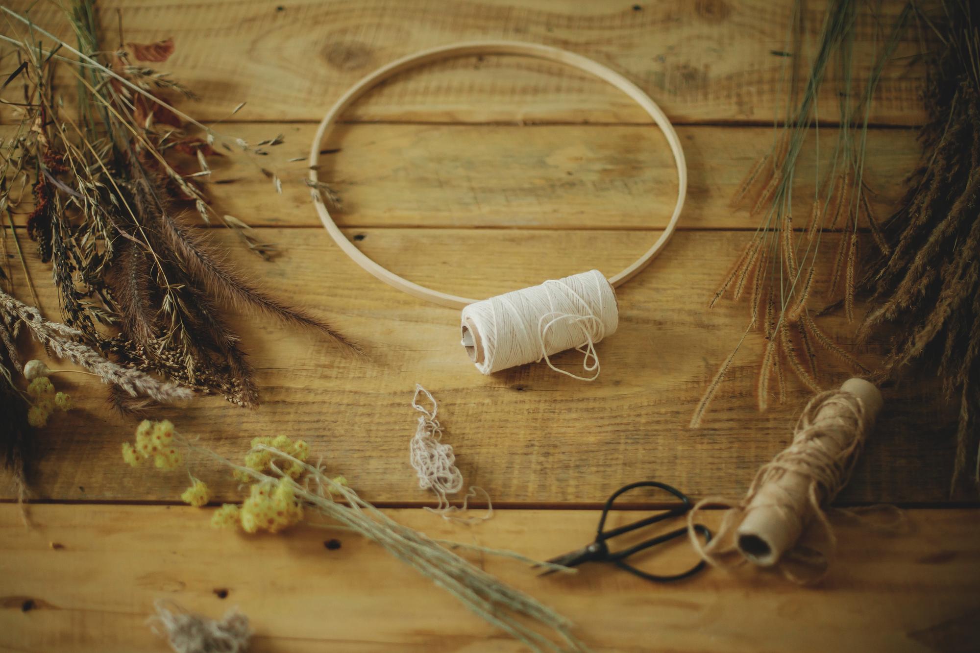 Workshop hands arranging threads and hoops